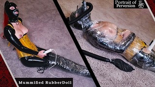 Rubberdoll este mumificat și făcut să slăbească: o fată iubitoare de latex, înfășurată în plastic, pe o baghetă magică