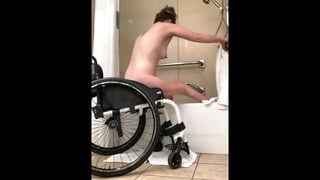 Disabled girl transferring from wheelchair to bathtub