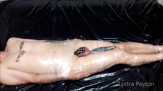 The mistress wraps the slave in plastic wrap and tortures him with vibrations on his full testicles