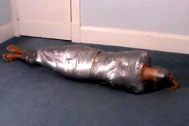Blonde girl wrapped in duct tape struggles